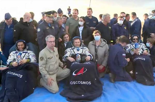After a year of service in space, 2 Russian cosmonauts and a NASA astronaut arrive on Earth